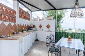 a kitchen with a table and chairs and a window at Casa Jema in Torrox