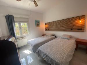 a bedroom with two beds and a window at Las fuentes in Alcossebre +27 photos
