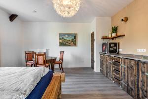 a bedroom with a bed and a table and chairs at Gutgemacht in Sankt Annen