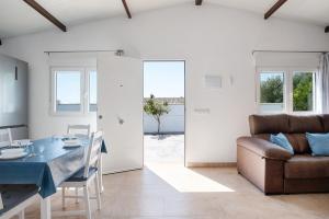 a living room with a table and a couch at Casa Naranjos in El Soto +14 photos