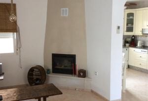 a living room with a fireplace in the corner at Casa Cuesta in Bolnuevo