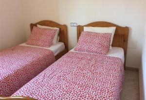 two beds sitting next to each other in a room at Casa Cuesta in Bolnuevo