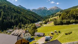 an aerial view of a small village in the mountains at Apartments Perfila Dolomitenblick in Valdaora +4 photos