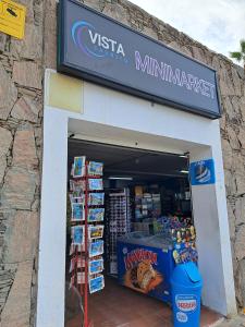 a store front of a store with a sign at Stunning Sunset Ocean View Apt in Taurito