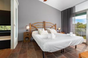 a bedroom with two beds and a balcony at Espectacular villa en Begur in Begur +22 photos