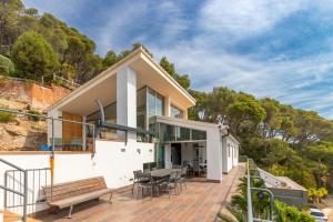 a house on a hill with a patio and a table at Espectacular villa en Begur in Begur