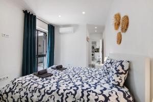 a bedroom with a bed and a large window at Amazing Oura Beach Apartment in Albufeira +16 photos
