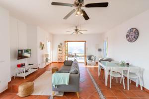 a living room with a couch and a table at Casa Arco Iris in Cómpeta