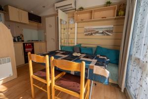 a kitchen with a table and chairs in a room at Mobilehome 4 personnes in Les Mathes