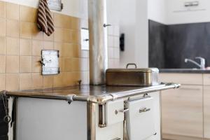 a kitchen with a pan on top of a counter at Ferienwohnung Sonnenstüble in Titisee-Neustadt +29 photos