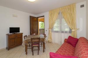 a living room with a couch and a table at Il Girasole - Mirto in Venturina Terme