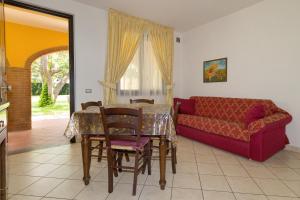 a living room with a table and a couch at Il Girasole - Mirto in Venturina Terme