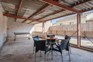 a patio with a ping pong table and chairs at La Garrofera in Aldover