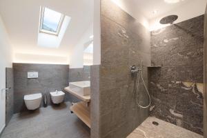 a bathroom with a sink and a toilet and a shower at Herrischner Apartement 1 in Moso +26 photos