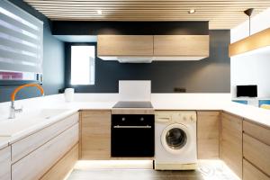 a kitchen with a washer and dryer in it at Etxe Ttippi in Saint-Jean-de-Luz +23 photos