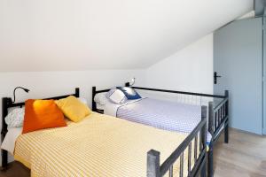 two beds sitting next to each other in a room at Etxe Ttippi in Saint-Jean-de-Luz