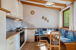 a kitchen with a table and a dining room at Glocklechnhof Sternenhimmel in Cadipietra