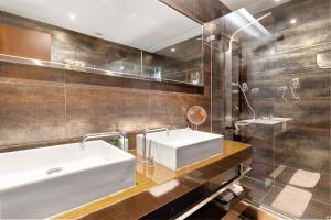 a bathroom with a white sink and a mirror at Casa dos Pinheiros in Apúlia +18 photos