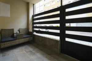 a room with two chairs and a window at Sophie Apartamentos - Burela in Burela de Cabo