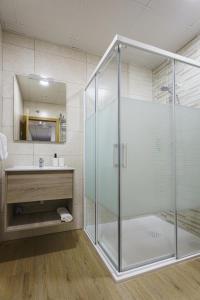 a glass shower in a bathroom with a sink at Sophie Apartamentos - Burela in Burela de Cabo +51 photos