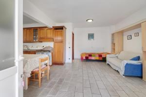 a kitchen and a living room with a couch at Il Faro in Celle Ligure