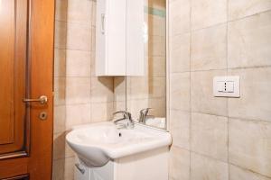 a bathroom with a sink and a mirror at Genzianella Tano di Grich in Cesani