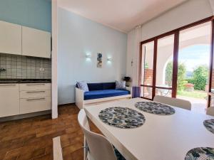 a kitchen and living room with a table and chairs at Casa Golfi di Lacona in Lacona +96 photos