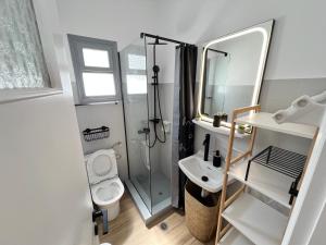 a bathroom with a shower and a toilet and a sink at aeolian blu 4 in Parikia +29 photos