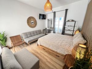 a living room with a bed and a couch at aeolian blu 4 in Parikia