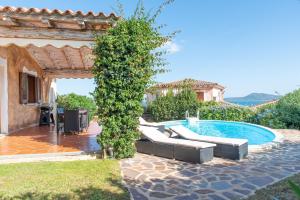a villa with a swimming pool and a house at Villetta Nicola in Olbia