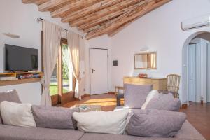 a living room with a couch and a tv at Villetta Nicola in Olbia