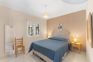 a bedroom with a blue bed and a chair at Casa Nero in San Fulgencio +27 photos