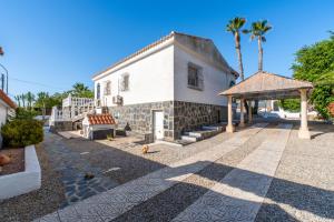 a white house with a gazebo and palm trees at Casa Nero in San Fulgencio