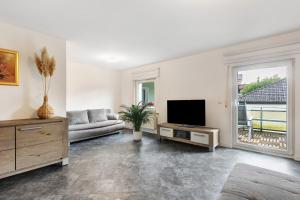 a living room with a couch and a flat screen tv at Fewo Schneider Bad Wildungen in Bad Wildungen