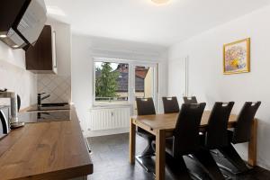 a kitchen and dining room with a wooden table and chairs at Fewo Schneider Bad Wildungen in Bad Wildungen