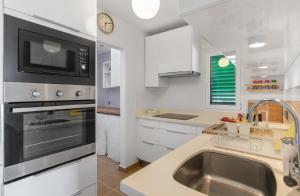 a kitchen with a sink and a microwave at 51 Avenue Playa Honda in Playa Honda +16 photos
