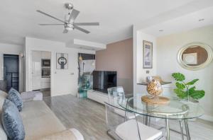 a living room with a glass table and a tv at 51 Avenue Playa Honda in Playa Honda
