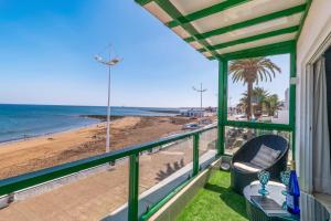 a balcony with a view of the beach at 51 Avenue Playa Honda in Playa Honda