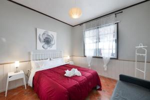 a bedroom with a red bed and a window at Los Lilos in Tijarafe +28 photos