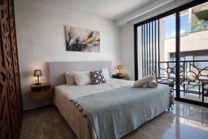 a bedroom with a bed and a large window at Luxury Penthouse with Ocean Views and Private Pool in Playa del Carmen +109 photos