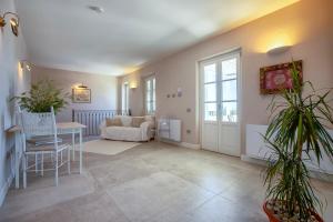 a living room with a couch and a table at Dimora Sella - Casa Monica in Alghero