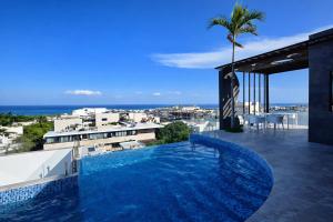 a swimming pool on the roof of a building at Luxury Penthouse with Ocean Views and Private Pool in Playa del Carmen
