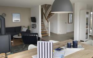 a living room and dining room with a table and a couch at Ferienhaus Olpenitz und Strand in Kappeln