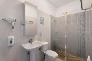 a bathroom with a toilet and a sink and a shower at Apartamentos Playa Azul - 4 in Vallehermoso +19 photos
