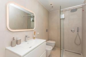 a bathroom with a sink and a glass shower at Spazio Pardo in Catania +44 photos