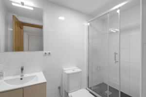 a bathroom with a shower and a toilet and a sink at Wonderful loft centre Manresa in Manresa +12 photos