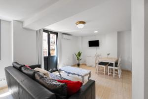 a living room with a couch and a table at Wonderful loft centre Manresa in Manresa