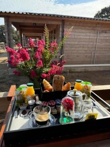 a tray with food and drinks on a table at Les Chalets De Tesa 4 in Occhiatana