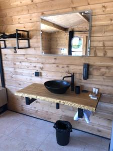 a bathroom with a sink and a mirror at Les Chalets De Tesa 4 in Occhiatana +10 photos