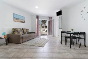 a living room with a couch and a table at Apartamento Las Flores4 in San Bartolomé